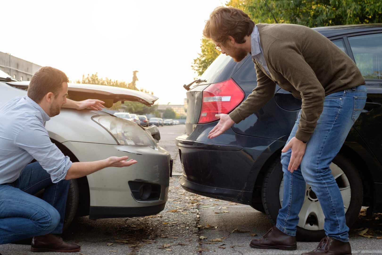 A man and woman arguing over the damage of their car.