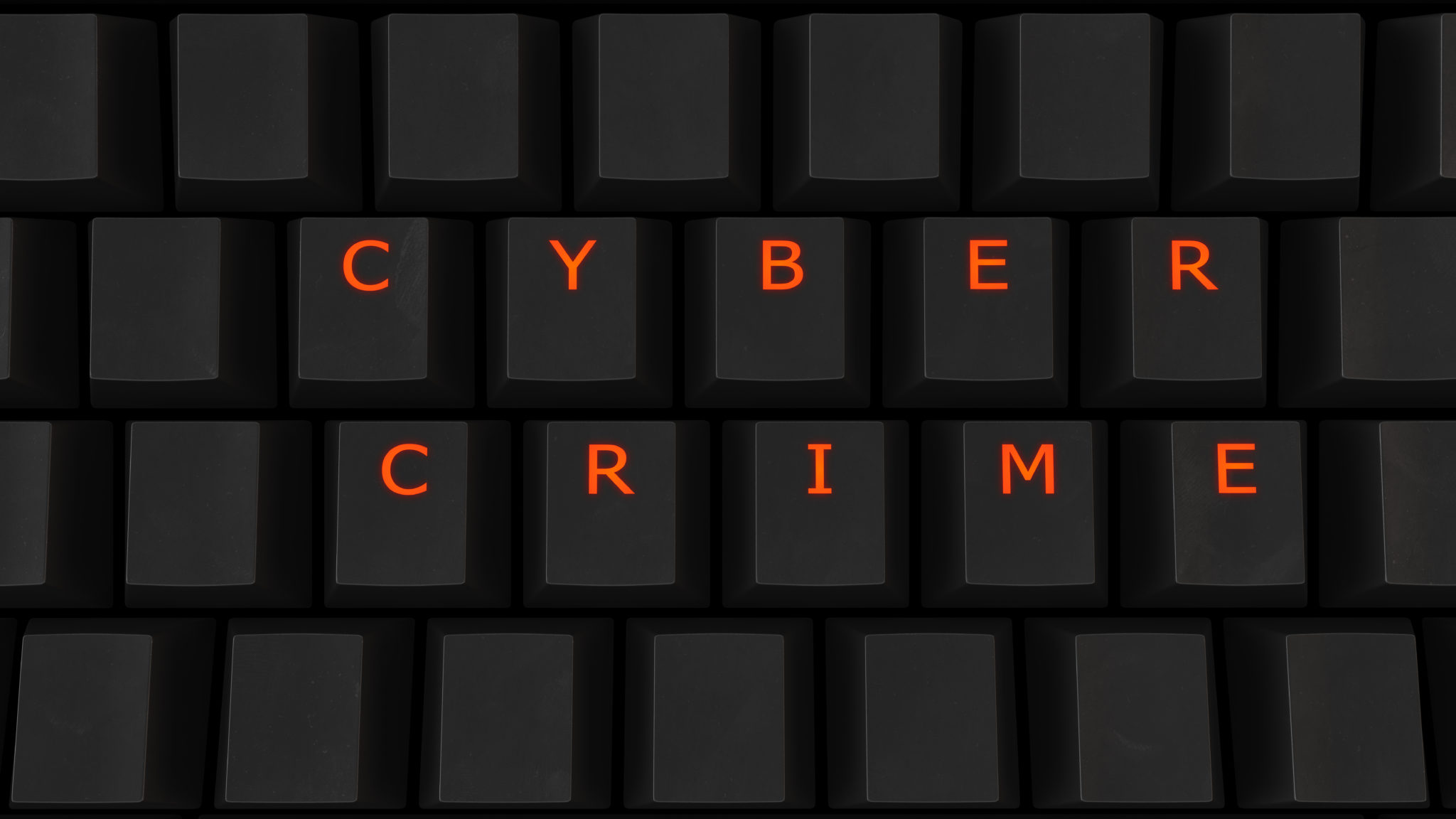 A keyboard with the words " cyber crime " written on it.